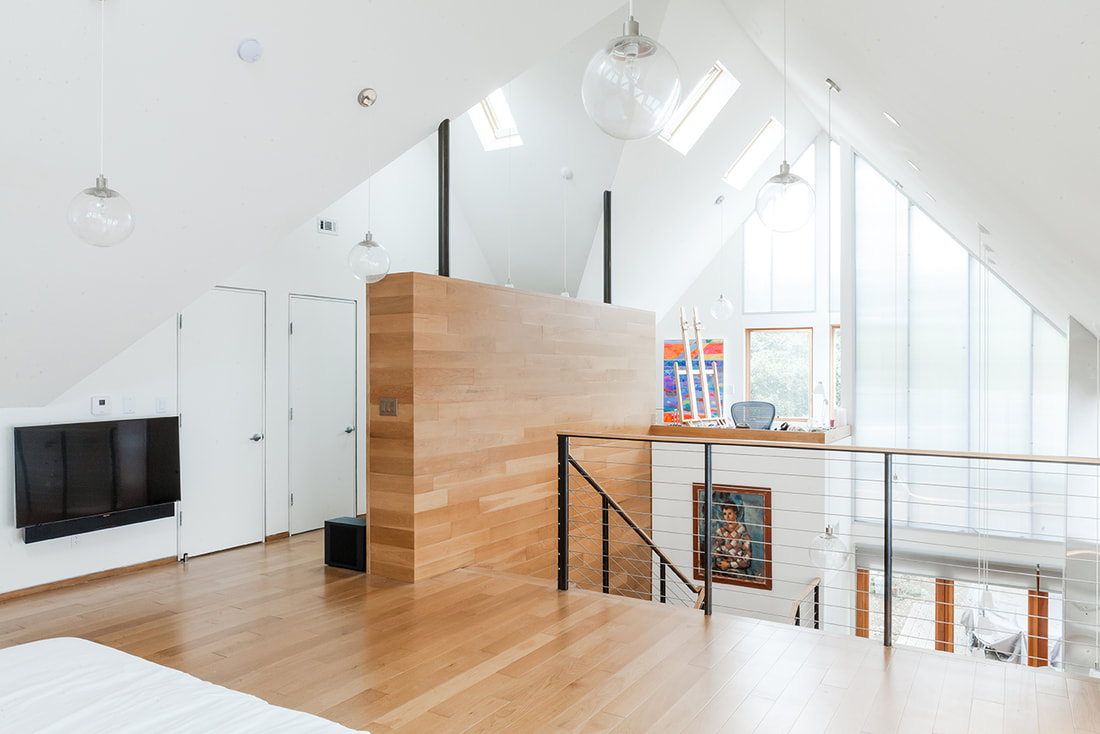 Coleman Griffith- interior architecture- wood panel wall contrasting against white walls. white, warm interior design